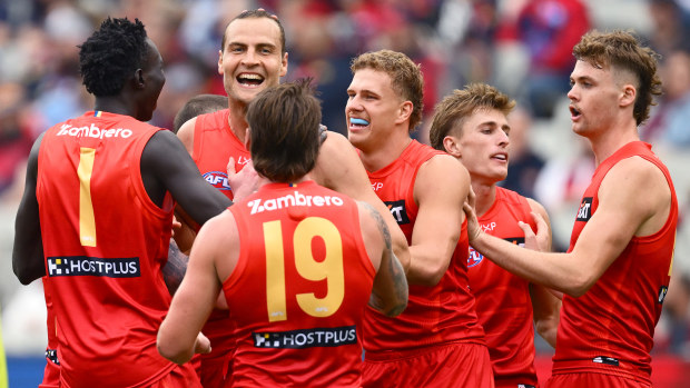 Gold Coast Suns celebrate their impressive win over Melbourne.