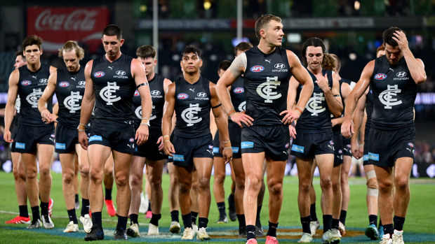 Carlton players trudge off.