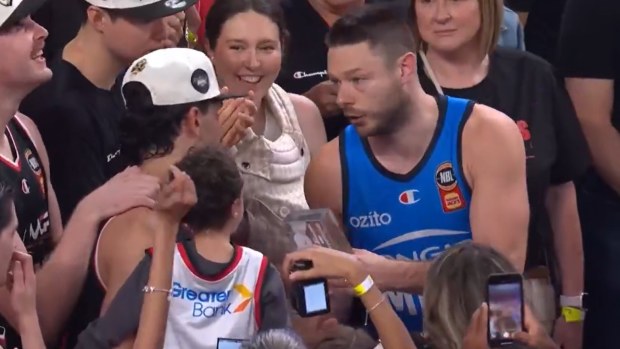 Matthew Dellavedova hands the MVP award to Will Hickey.