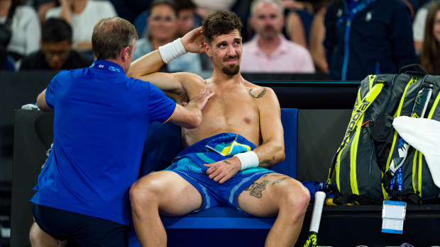 Thanasi Kokkinakis of Australia receives treatment on his shoulder.
