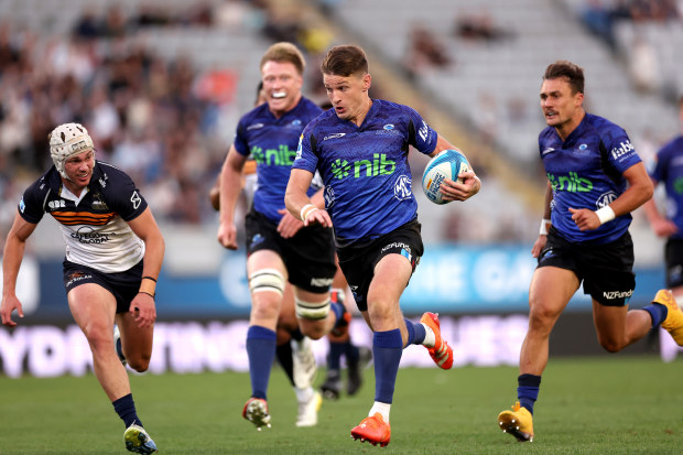Beauden Barrett of the Blues runs in for a try.