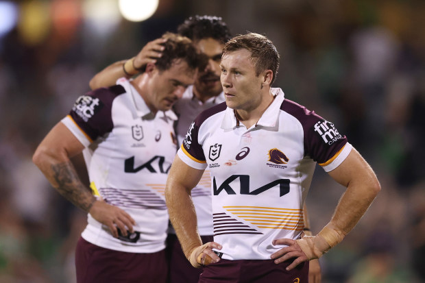 Broncos players look dejected after defeat.