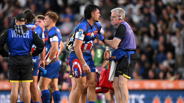 Ngatungane Punivai of the Hurricanes receives medical attention.