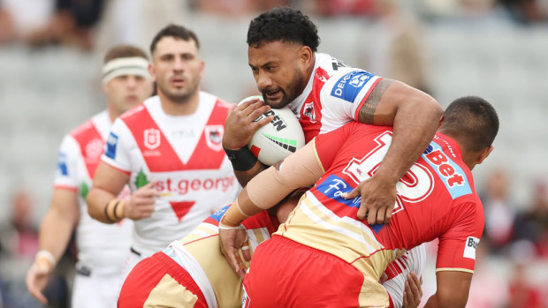 Francis Molo of the Dragons is tackled by Connelly Lemuelu of the Dolphins.