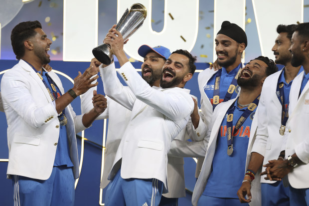India's Virat Kohli and teammates celebrate with the trophy of the ICC Champions Trophy.