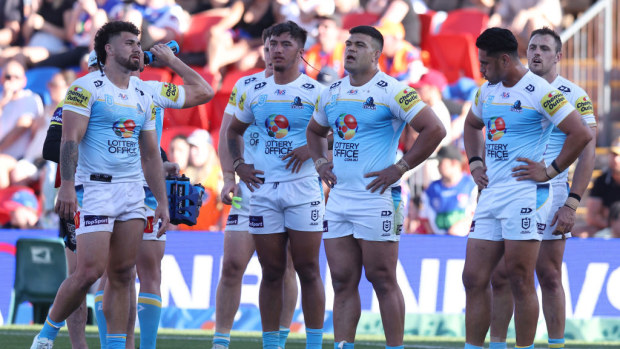 Titans players react to a Knights try.