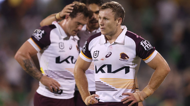 Broncos players look dejected after defeat.