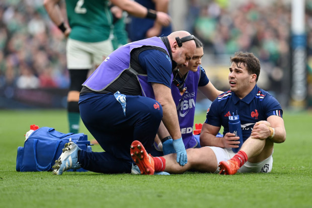 Antoine Dupont of France reacts as he receives medical treatment.
