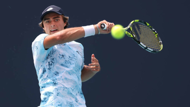 Adam Walton of Australia returns a shot against Coleman Wong of Hong Kong at the Miami Open.