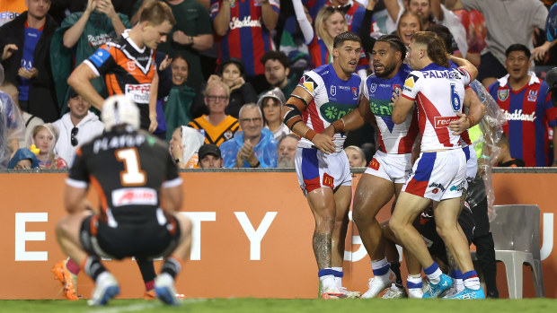 Greg Marzhew of the Knights celebrates with teammates after scoring a try during the round one NRL match between the Wests Tigers and Newcastle Knights at Campbelltown Sports Stadium on March 07, 2025, in Sydney, Australia. (Photo by Mark Metcalfe/Getty Images)