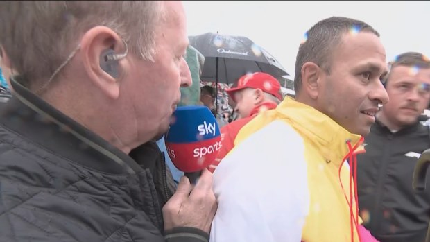 Usman Khawaja seen on the grid prior to the Australian F1 Grand Prix after withdrawing from Queensland's Sheffield Shield match against South Australia.