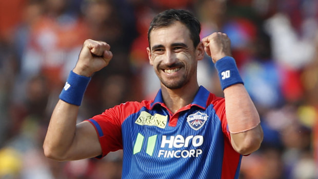 Mitchell Starc celebrates the wicket of Ishan Kishan during the match at ACAVDCA Cricket Stadium.