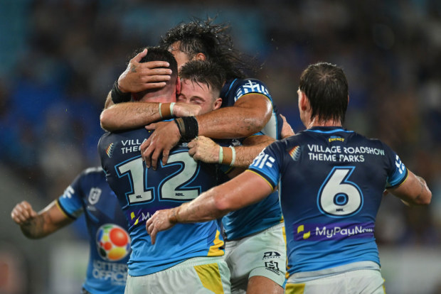 Beau Fermor of the Titans celebrates with teammates after scoring a try.