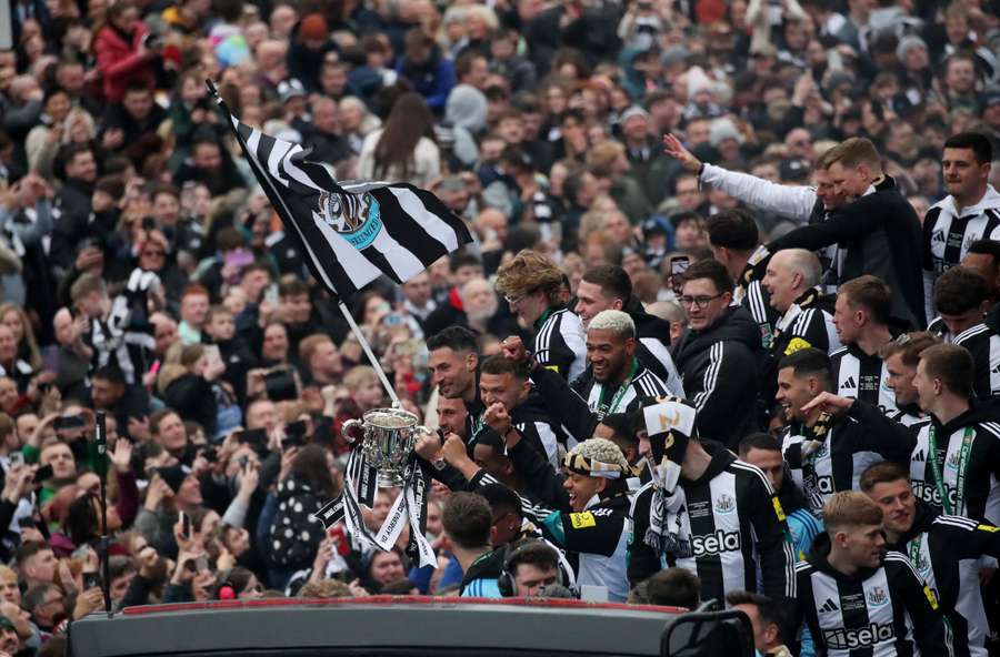 Newcastle United's Fabian Schar holds the Carabao Cup trophy on the bus during the victory parade