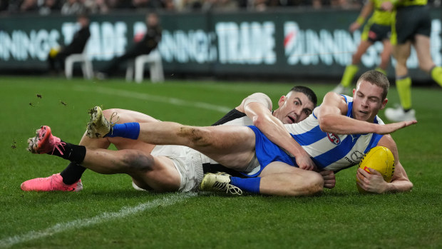 Brayden Maynard tackles Tom Powell during the round 14 AFL match between North Melbourne and Collingwood