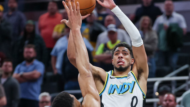 Tyrese Haliburton #0 of the Indiana Pacers makes a three-point shot while being fouled by Giannis Antetokounmpo #34 of the Milwaukee Bucks.