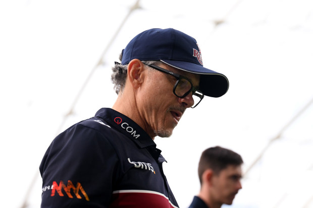 Coach Les Kiss of the Reds looks on.