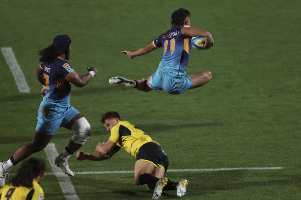 Kyren Taumoefolau hurdles Ruben Love.
