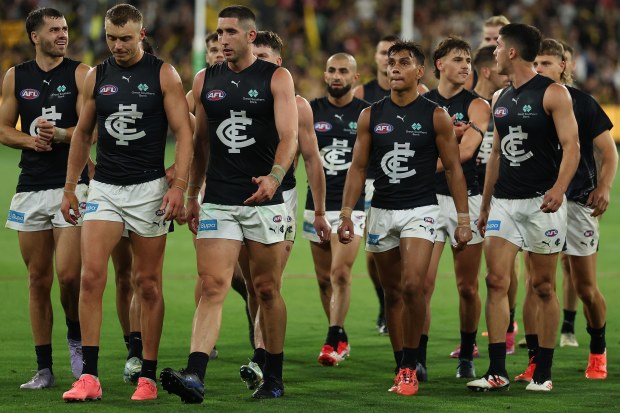 Carlton players walk off the field after their loss to Richmond.
