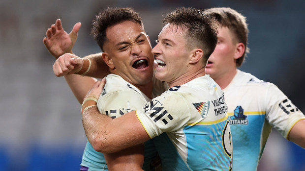 Phillip Sami of the Titans celebrates with teammates after scoring a try