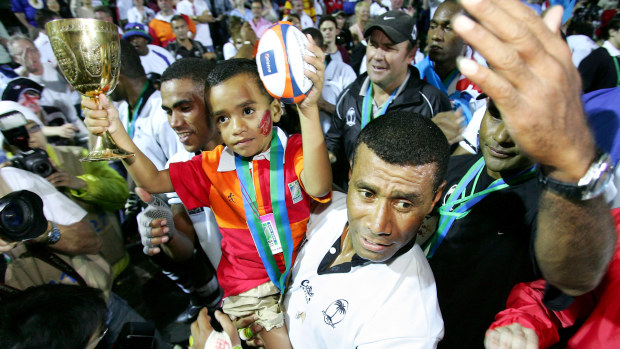 Captain Waisale Serevi of Fiji and his son Serevi Jr celebrate after defeating New Zealand.