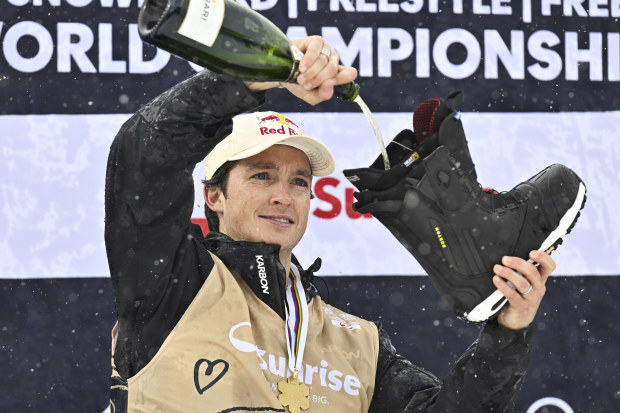 Scotty James tipping champagne into one of his boots before chugging down a shoey.