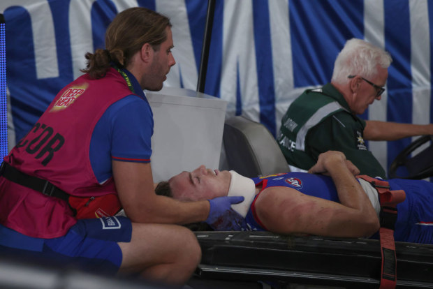 Luke Cleary of the Bulldogs is taken from the ground on a stretcher.