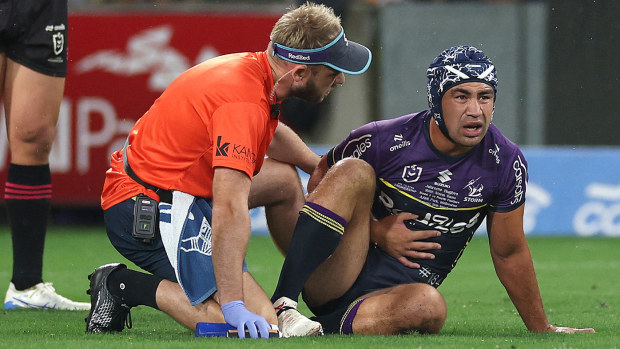 Jahrome Hughes of the Storm is attended to by trainers after a collision during the round three NRL match between the Melbourne Storm and Penrith Panthers at AAMI Park on March 20, 2025, in Melbourne, Australia. (Photo by Daniel Pockett/Getty Images)