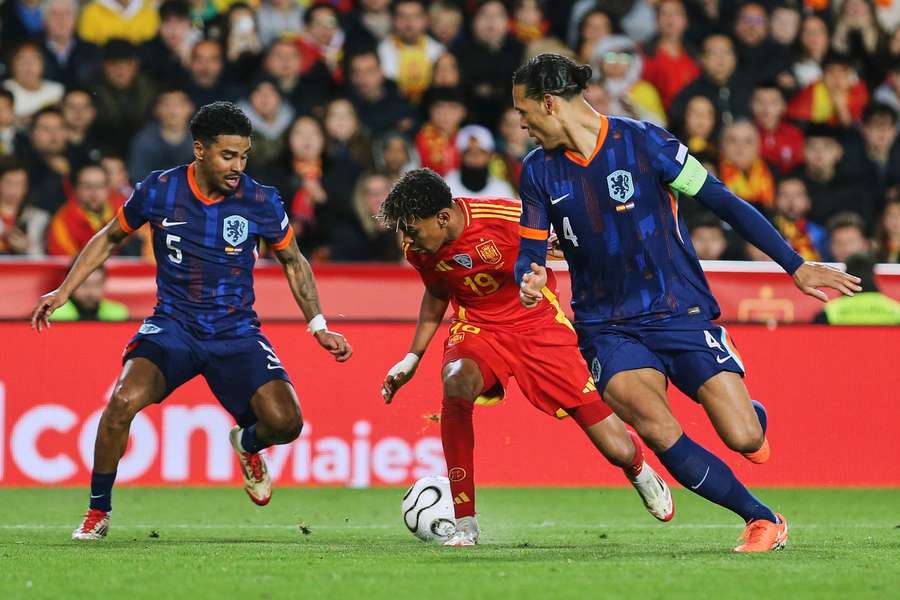 Spain's Lamine Yamal takes on The Netherlands' Ian Maatsen and Virgil van Dijk (R) during their UEFA Nations League meeting