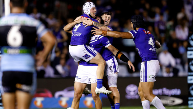 Reed Mahoney and Jack Todd of the Bulldogs celebrate after defeating the Sharks to remain unbeaten in 2025.