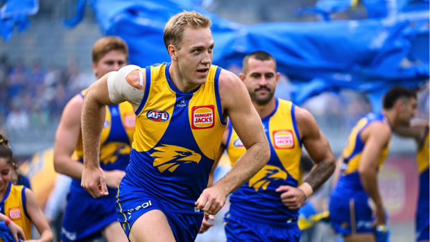 West Coast's Oscar Allen leads his team out onto the field.