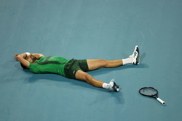 Novak Djokovic of Serbia lies on the court after losing a point against Jakub Mensik of the Czech Republic during the second set of the men's singles final on the final day of the Miami Open Presented by Itau 2025 at Hard Rock Stadium on March 30, 2025 in Miami Gardens, Florida. (Photo by Matthew Stockman/Getty Images)