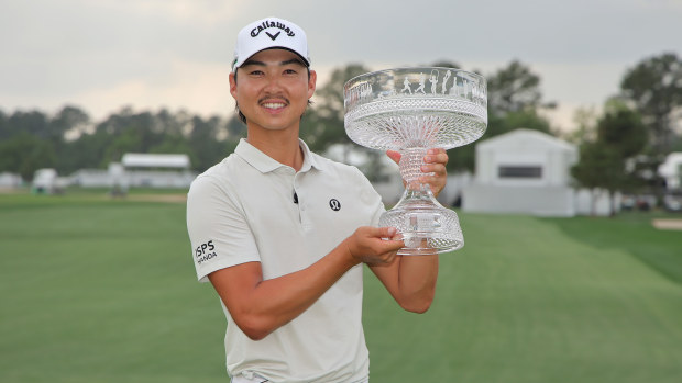 Min Woo Lee of Australia celebrates with the trophy after winning the Texas Children's Houston Open 2025 at Memorial Park Golf Course on March 30, 2025 in Houston, Texas. (Photo by Jonathan Bachman/Getty Images)
