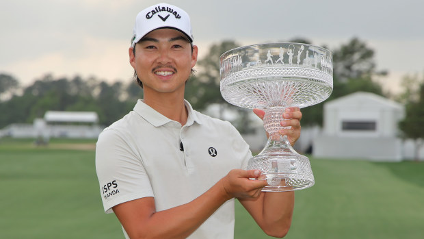 Min Woo Lee of Australia celebrates with the trophy after winning the Texas Children's Houston Open 2025 at Memorial Park Golf Course on March 30, 2025 in Houston, Texas. (Photo by Jonathan Bachman/Getty Images)