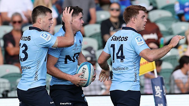 Teddy Wilson of the Waratahs is congratulated on scoring a try.