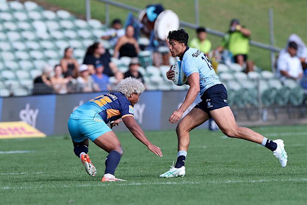 Joseph-Aukuso Suaalii of the Waratahs is challenged by Fine Inisi of Moana Pasifika.