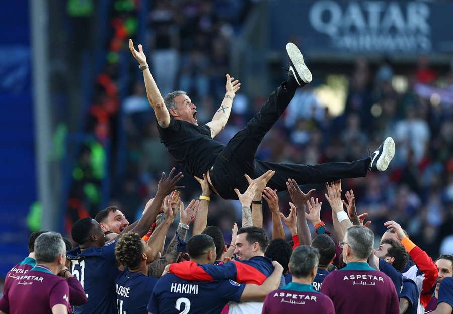 Paris Saint-Germain coach Luis Enrique celebrates with the players after winning Ligue 1