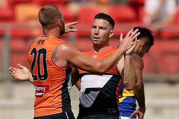 Toby Greene of the Giants celebrates with teammates after kicking a goal against the Eagles.