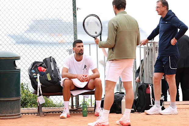 Novak Djokovic chats with his brother Marko beside the practice court at the Rolex Monte-Carlo Masters.