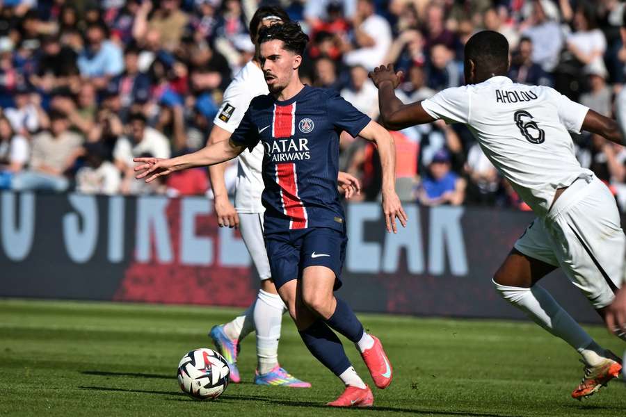 PSG’s midfielder Vitinha fights for the ball against Angers