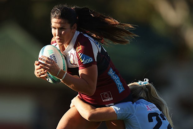 Charlotte Caslick of the Reds is tackled.