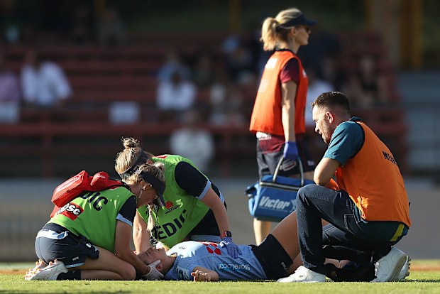 Maya Stewart of the Waratahs receives treatment after a tackle.