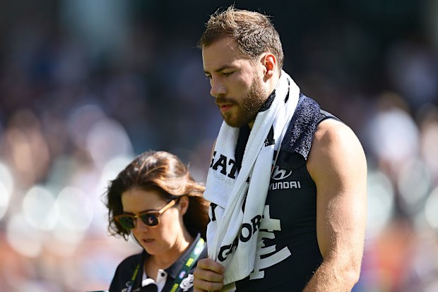Harry McKay of the Blues walks from the field after being concussed.