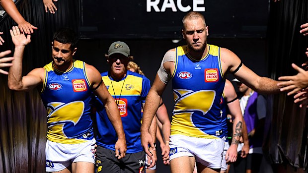 Oscar Allen of West Coast leads his team onto the field against Carlton Blues.