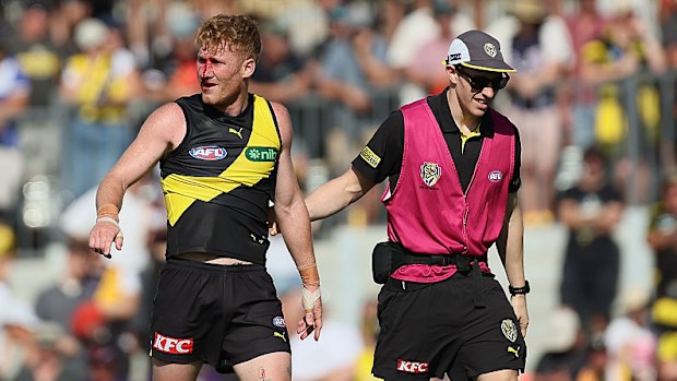 Nick Vlastuin of the Tigers goes off injured.