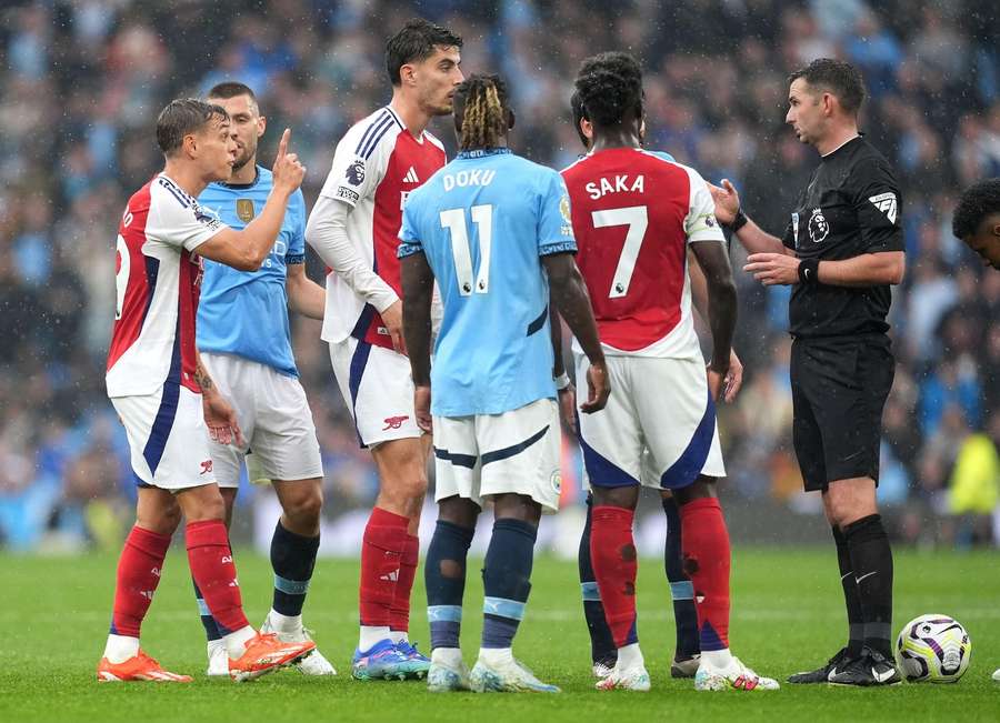Arsenal's Leandro Trossard shown a red card by referee Michael Oliver during the Premier League match at the Etihad Stadium, Manchester