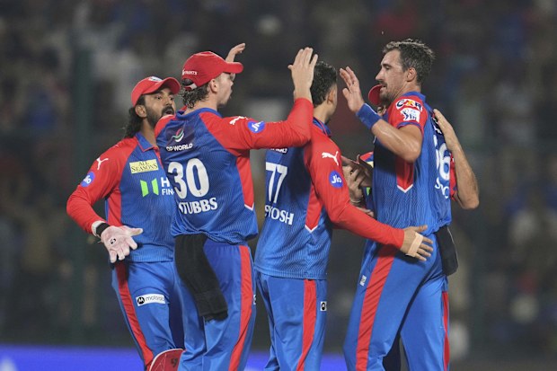 Delhi Capitals' Mitchell Starc celebrates with teammates.