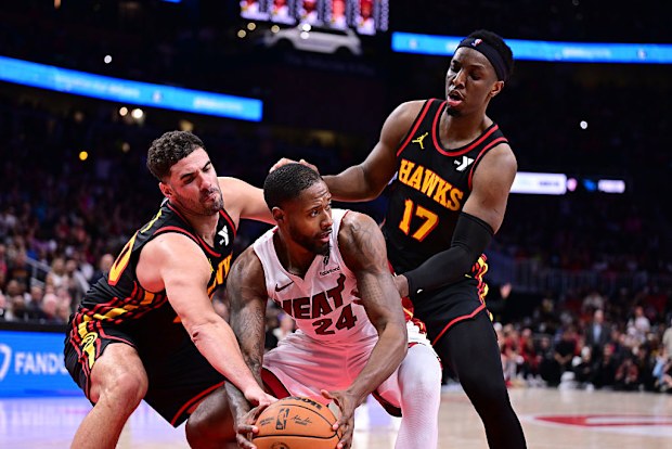Haywood Highsmith #24 of the Miami Heat controls the ball as Georges Niang #20 of the Atlanta Hawks attempts to steal.