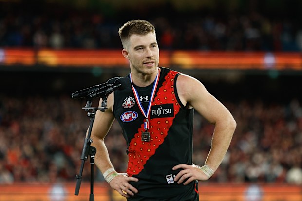 Zach Merrett of the Bombers receiving the Anzac Day Medal.