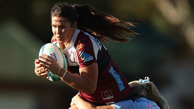 Charlotte Caslick of the Reds is tackled.